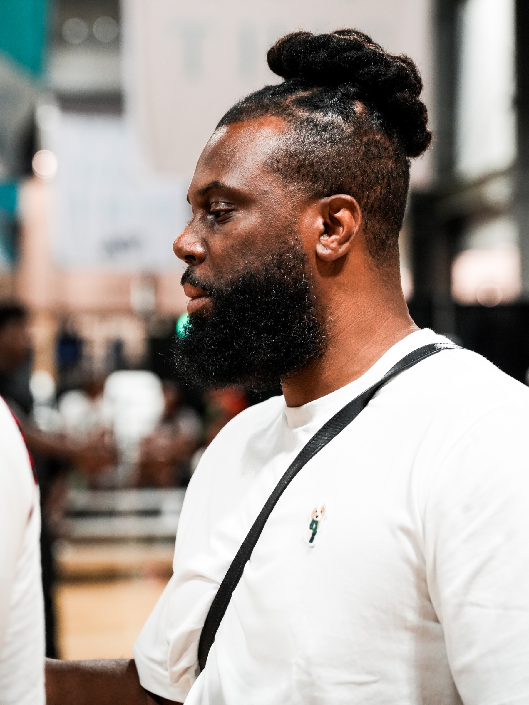 Nelson Ossé watching from the sideline during basketball practice.